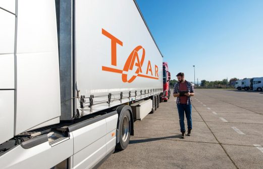 truck-driver-inspecting-vehicle-trailer-tires-before-driving